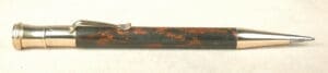 Antique gold mechanical pencil, copper accents.