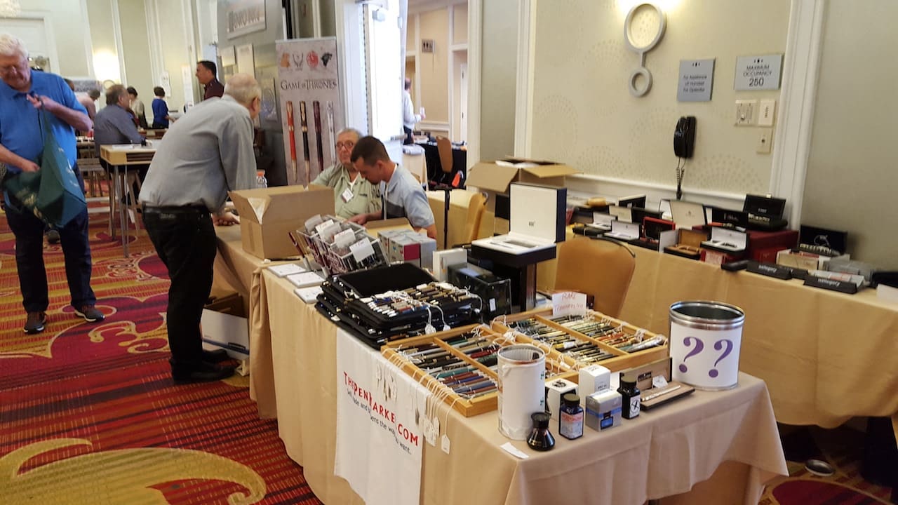 Trade show table with assorted merchandise displayed.