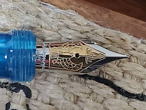 Fountain pen nib with intricate design.