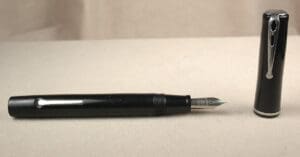 Black fountain pen with detached cap.