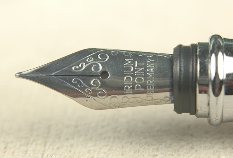 Fountain pen nib with intricate engravings.