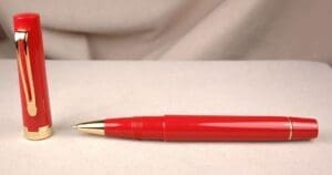 Red fountain pen with gold accents.