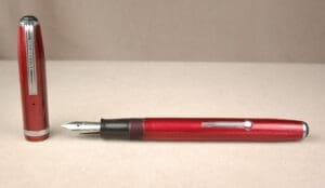 Red fountain pen with detachable cap.