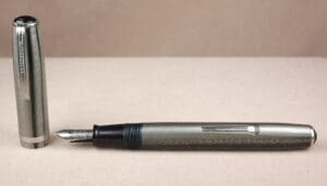 Silver fountain pen with detachable cap.