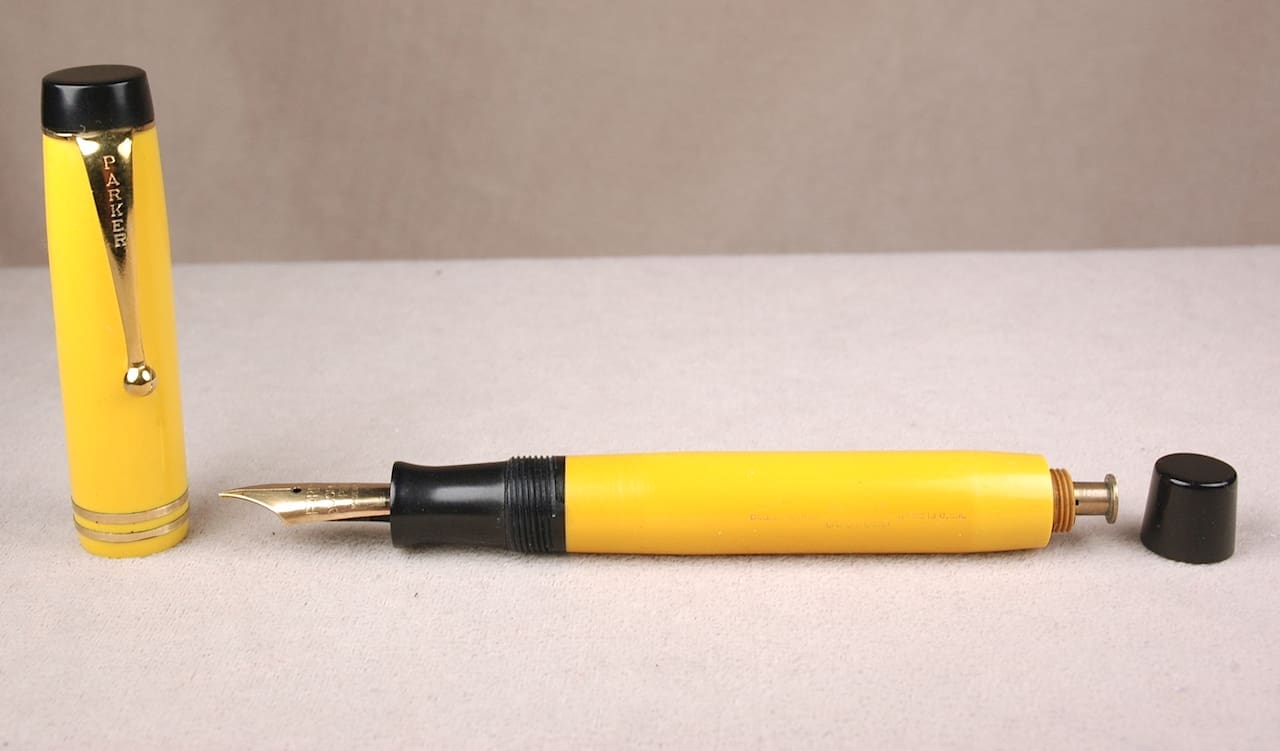 Yellow fountain pen with open cap.
