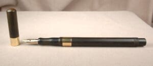 Black and gold fountain pen with cap.