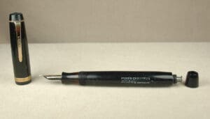 Black vintage fountain pen with cap removed.