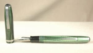 Green fountain pen with cap on display.
