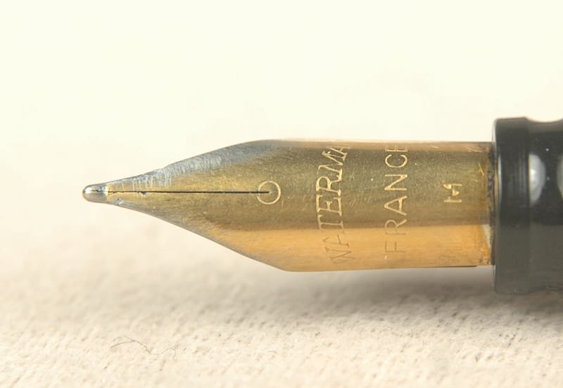 Fountain pen nib close-up on paper.
