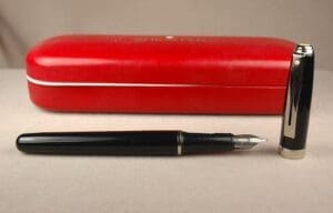 Black fountain pen with red case.