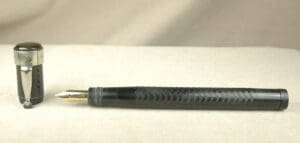 Black fountain pen with detached cap.