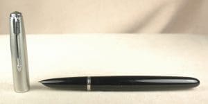 Black fountain pen with silver cap.