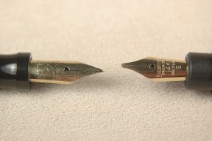 Two fountain pen nibs facing each other.