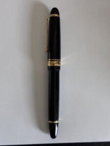 Black pen with gold accents on paper.