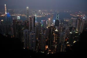 Hong Kong skyline at night, illuminated buildings.