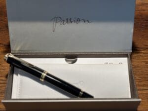 Black pen in an open gift box.