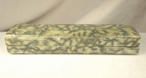 Patterned rectangular jewelry case on white background.