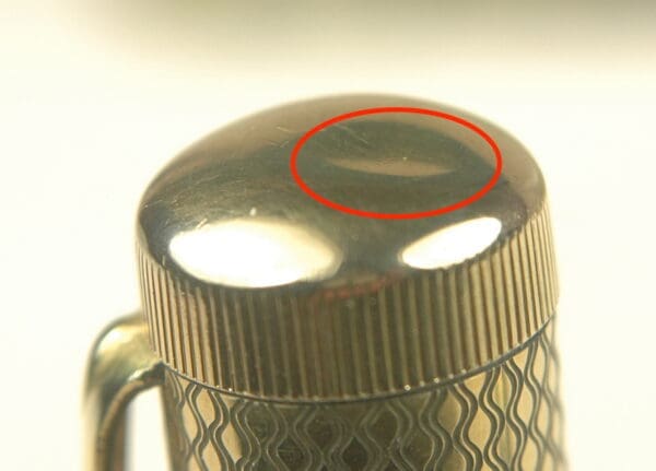 Metallic object with a red-circled area.