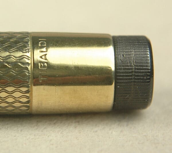 Gold and black pen with textured grip.