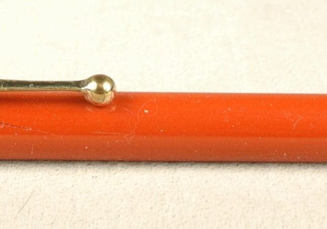Red mechanical pencil with metal accents.