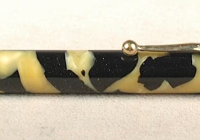 Black and yellow patterned pen with clip.